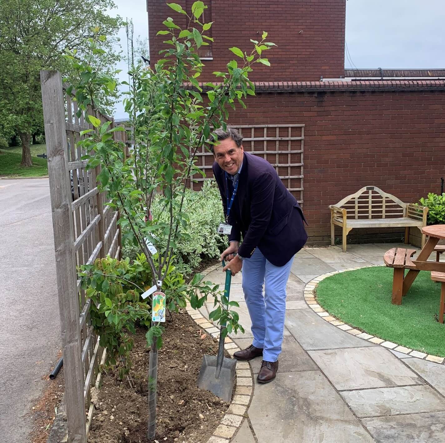 CEO David Archer planting a tree